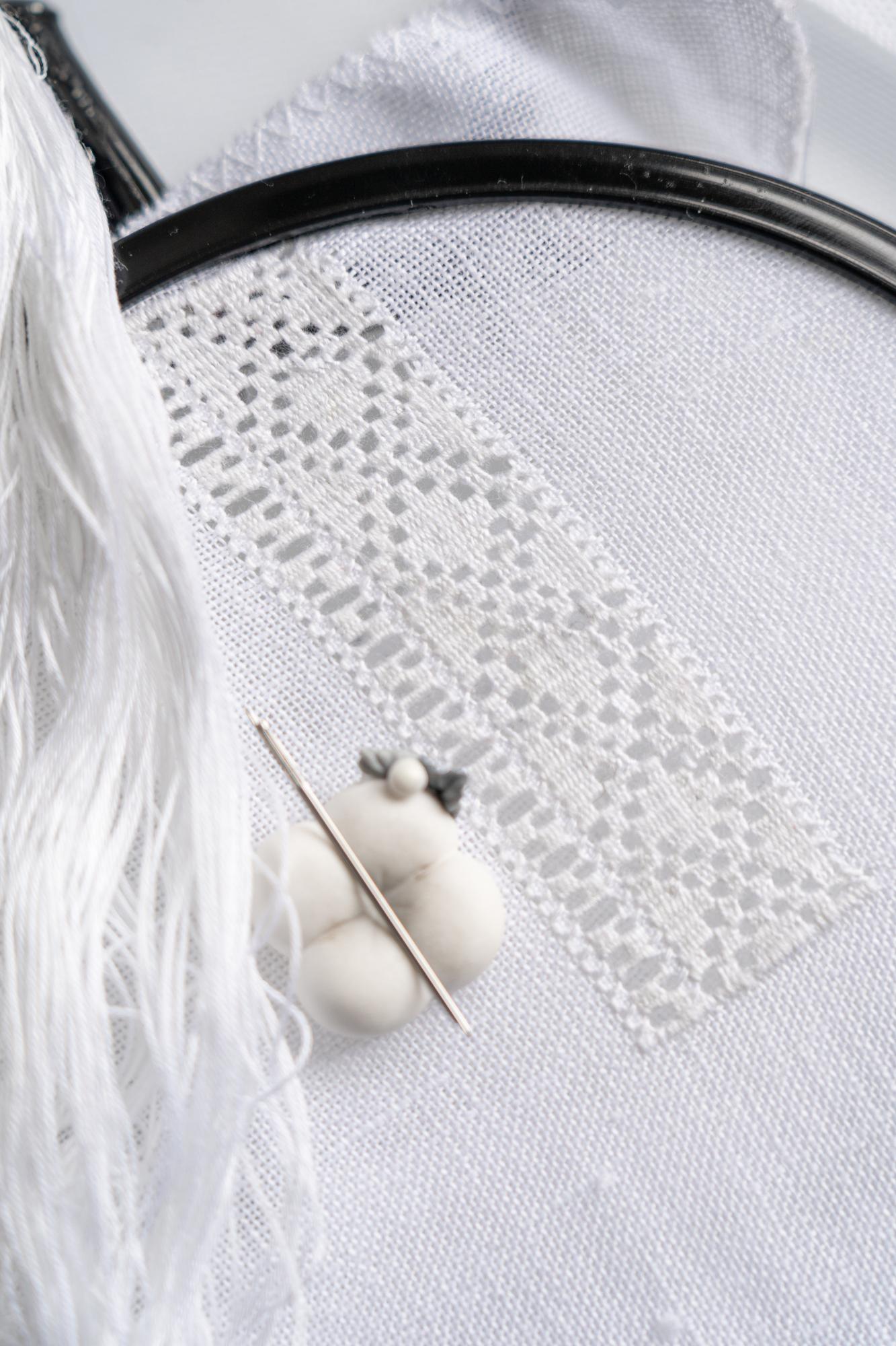 Hand-stitched monogram detail
