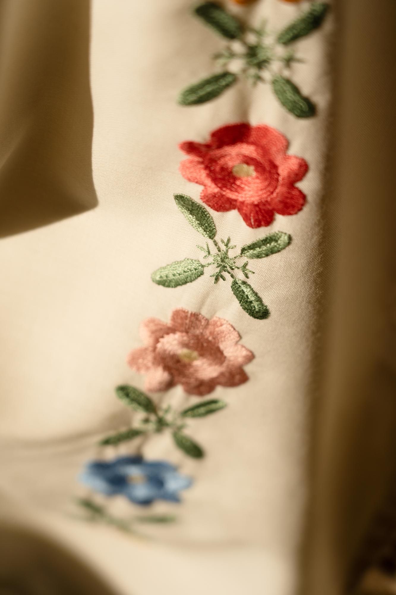 Close-up of embroidered floral pattern on linen